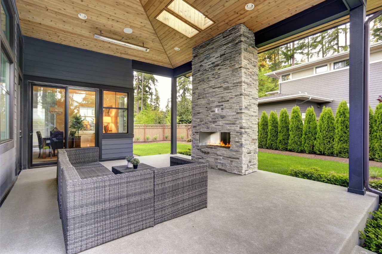 A modern patio with a fireplace and outdoor furniture near Providence, Rhode Island (RI)